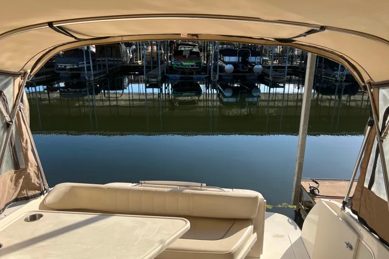 Slide: The Image of 1999 Sea Ray 290 Sundancer interior view with marina backdrop. - 6