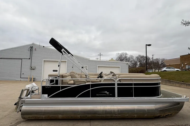 The Image of 2015 Bennington 18 SLX pontoon boat parked outdoors on a cloudy day. - 0