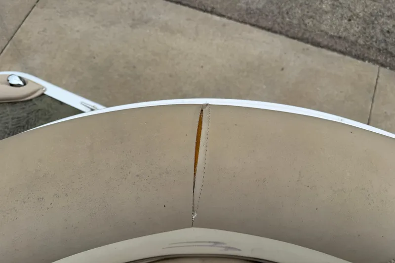 Slide: The Image of 2015 Bennington 18 SLX boat seat with visible tear in upholstery. - 11