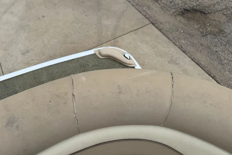 Slide: The Image of Close-up of 2015 Bennington 18 SLX boat seat with visible wear and stitching. - 13