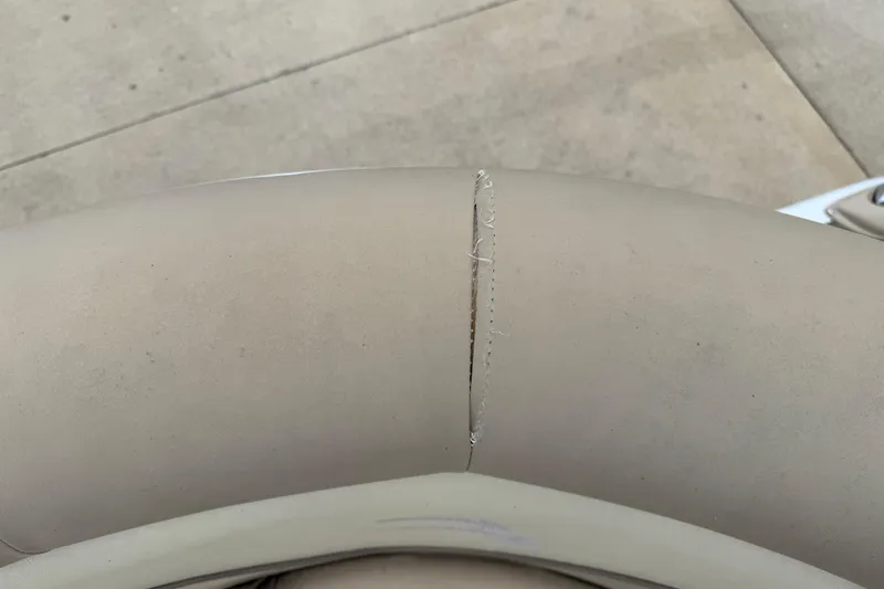 Slide: The Image of Torn upholstery on 2015 Bennington 18 SLX boat seat, showing wear and tear. - 15