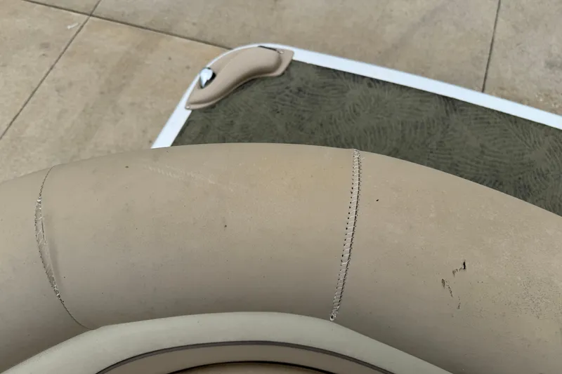 Slide: The Image of Close-up of 2015 Bennington 18 SLX boat seat with visible stitching and minor wear. - 16