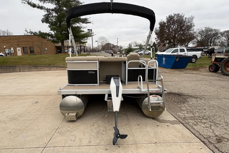 Slide: The Image of 2015 Bennington 18 SLX pontoon boat parked on concrete surface. - 2