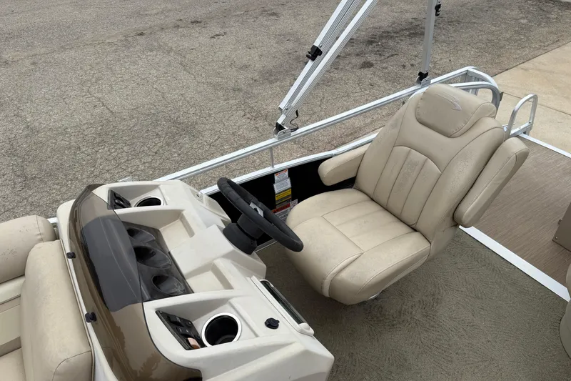 Slide: The Image of 2015 Bennington 18 SLX boat interior with beige captain's chair and steering console. - 20