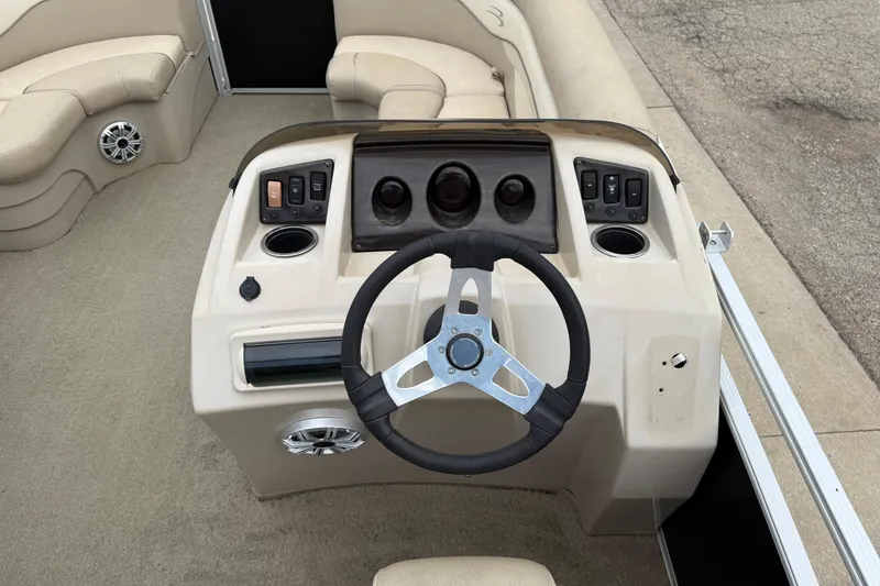 Slide: The Image of 2015 Bennington 18 SLX boat dashboard with steering wheel and control panel. - 22