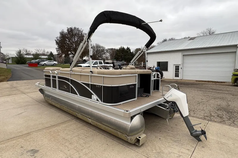 Slide: The Image of 2015 Bennington 18 SLX pontoon boat parked on driveway near garage. - 3