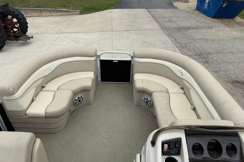 Slide: The Image of 2015 Bennington 18 SLX pontoon boat interior with beige seating and control panel. - 9