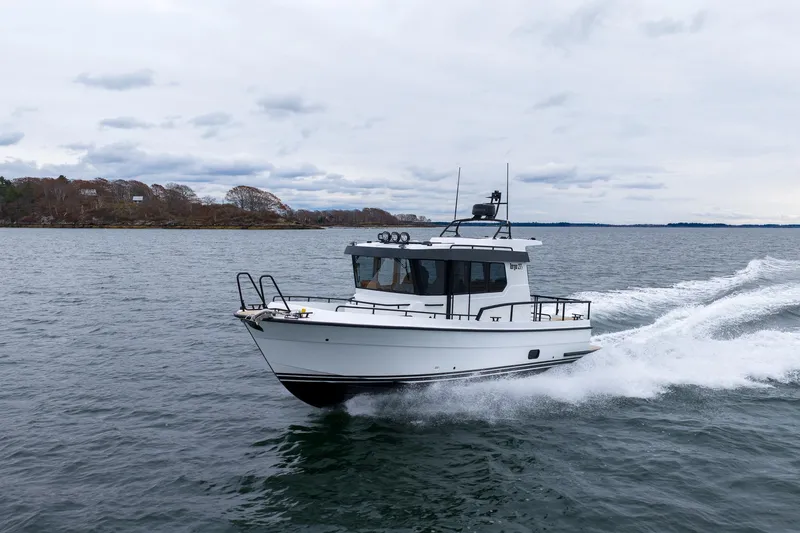 Slide: The Image of 2026 Targa 27.2 boat cruising on open water under cloudy skies. - 1