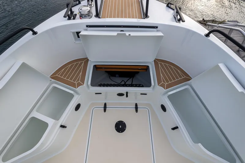 Slide: The Image of 2026 Targa 27.2 boat interior with open storage compartments and wooden deck accents. - 11