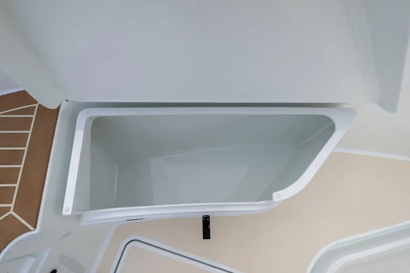 Slide: The Image of Open storage compartment on 2026 Targa 27.2 boat, featuring sleek white interior design. - 14