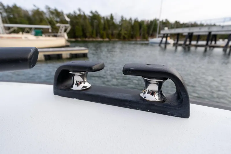 Slide: The Image of Close-up of Targa 27.2 boat cleat, 2026 model, docked by a scenic waterfront. - 16