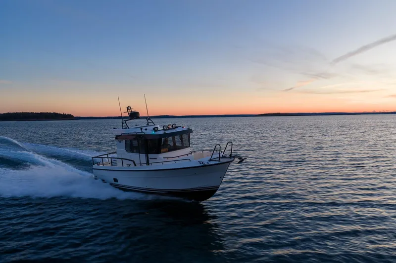 Slide: The Image of Targa 27.2 boat cruising at sunset, 2026 model, on open water. - 2