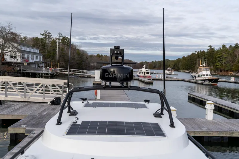 Slide: The Image of 2026 Targa 27.2 boat docked, featuring Garmin equipment and solar panels, in a serene marina setting. - 22
