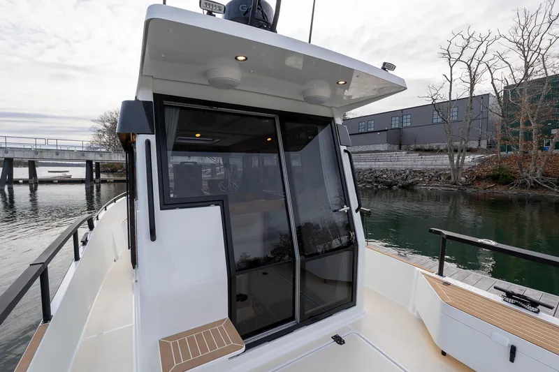 Slide: The Image of 2026 Targa 27.2 boat docked by a scenic waterfront with modern design. - 24