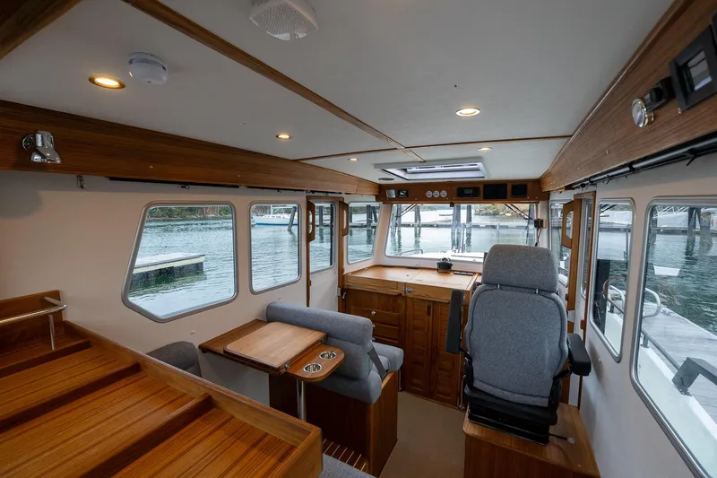 Slide: The Image of Interior of 2026 Targa 27.2 boat with wooden finishes and large windows. - 25