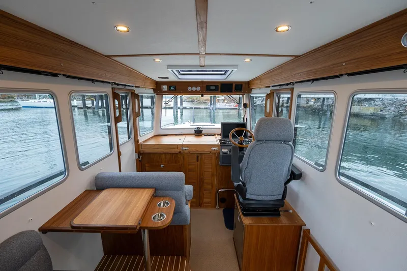 Slide: The Image of Interior of 2026 Targa 27.2 boat with wooden accents and large windows. - 26