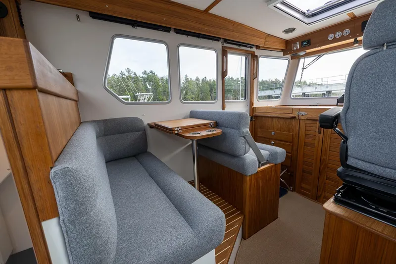 Slide: The Image of Interior of 2026 Targa 27.2 boat with wooden accents and gray seating. - 28