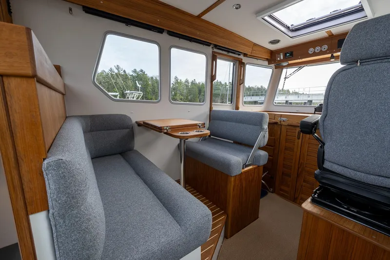 Slide: The Image of Interior of 2026 Targa 27.2 boat with gray seating and wooden accents. - 29