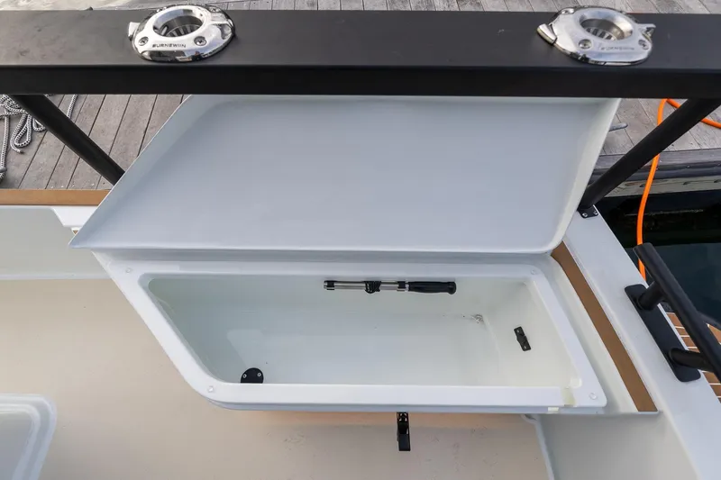 Slide: The Image of Open storage compartment on 2026 Targa 27.2 boat, dockside view. - 3