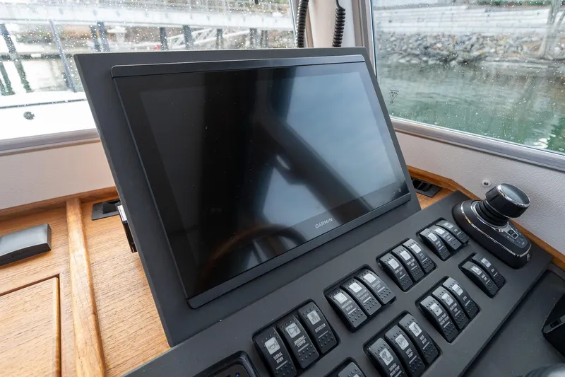 Slide: The Image of Control panel of 2026 Targa 27.2 boat with Garmin display and switches. - 34