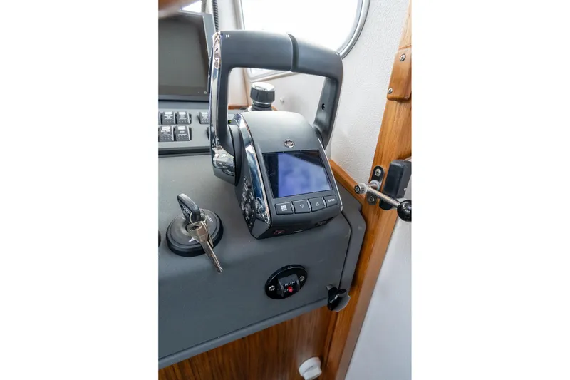 Slide: The Image of Control panel of 2026 Targa 27.2 boat with keys and display screen. - 35