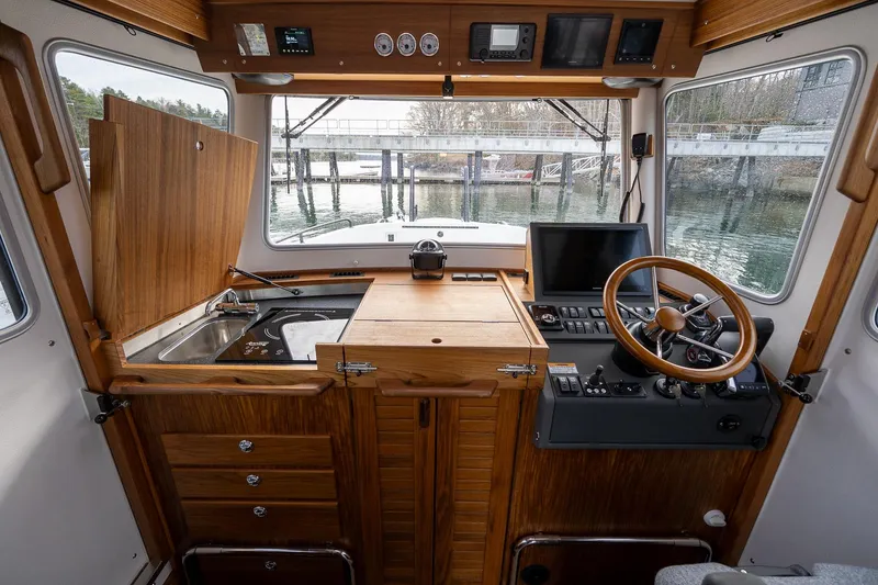 Slide: The Image of Interior of 2026 Targa 27.2 boat with wooden cabinetry and modern navigation controls. - 41