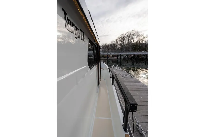 Slide: The Image of Side view of 2026 Targa 27.2 boat docked by a wooden pier. - 5