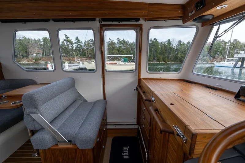 Slide: The Image of Interior of 2026 Targa 27.2 boat with wooden cabinetry and gray seating. - 52