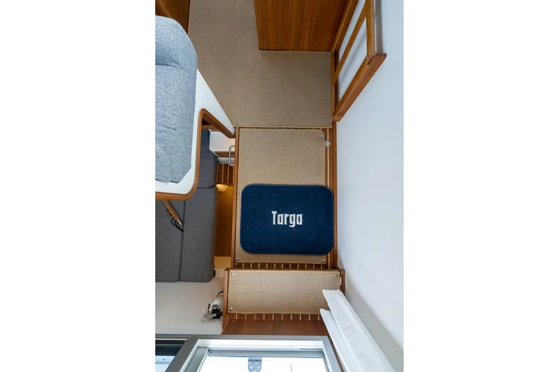 Slide: The Image of Interior of 2026 Targa 27.2 boat with carpeted flooring and seating area. - 57
