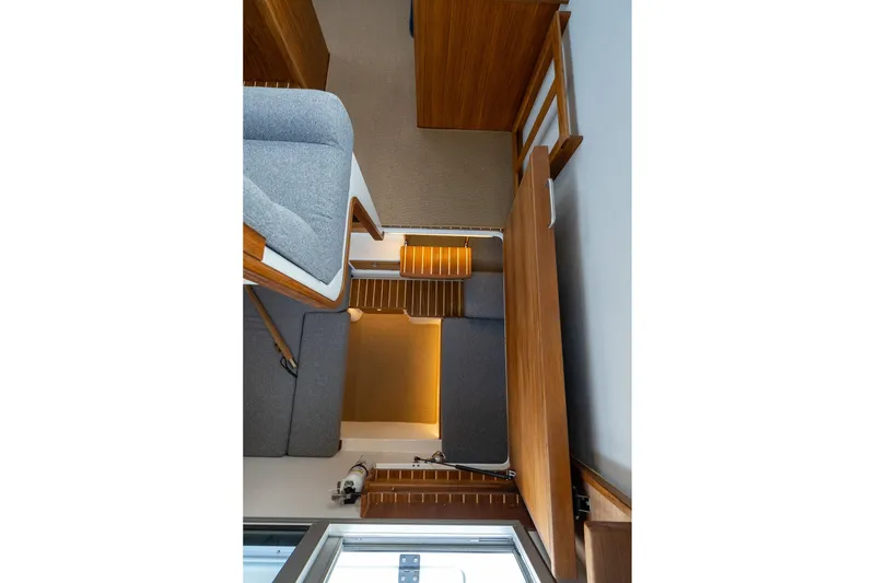 Slide: The Image of Interior of 2026 Targa 27.2 boat with wooden and gray fabric furnishings. - 58