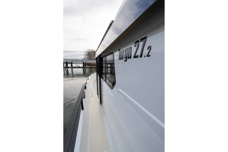 Slide: The Image of Side view of 2026 Targa 27.2 boat docked by the water. - 6