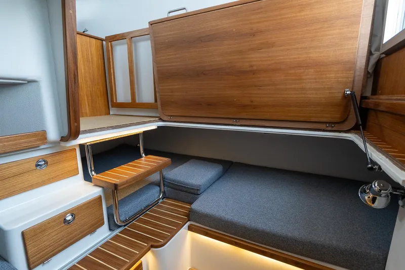 Slide: The Image of Interior of 2026 Targa 27.2 boat with wooden accents and cozy seating area. - 62