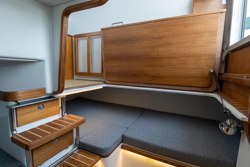 Slide: The Image of 2026 Targa 27.2 cabin interior with wooden accents and cozy seating area. - 63
