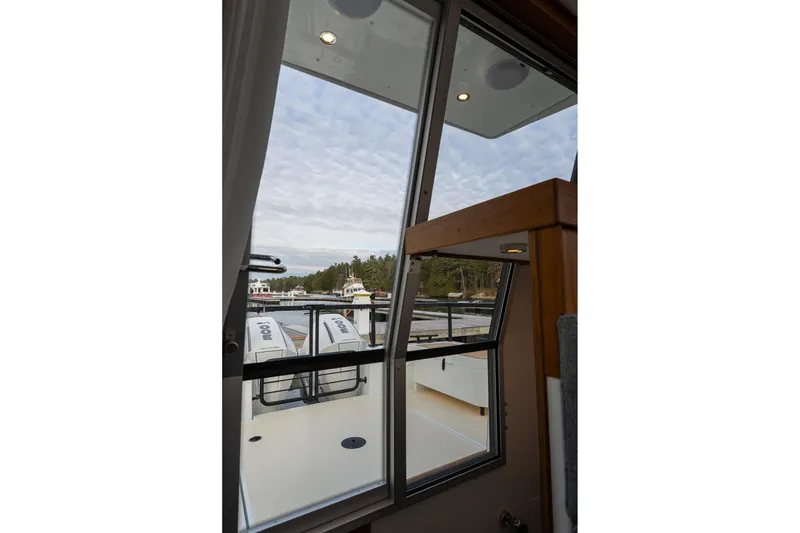 Slide: The Image of View from inside a 2026 Targa 27.2 boat, showing the deck and engines. - 64