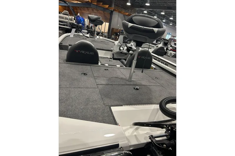 Slide: The Image of 2024 Vexus AVX1880C boat interior with seating and carpeted deck. - 6