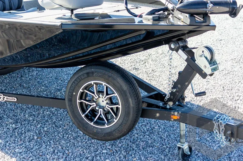 Slide: The Image of 2026 G3 Sportsman 1610 boat trailer with wheel and winch on gravel surface. - 21