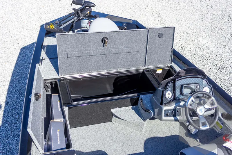 Slide: The Image of 2026 G3 Sportsman 1610 boat interior with open storage and steering console. - 27
