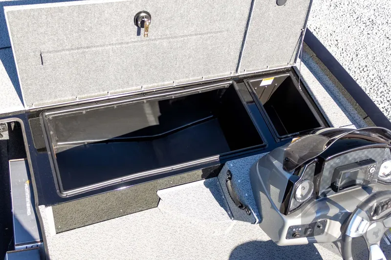 Slide: The Image of 2026 G3 Sportsman 1610 boat interior with open storage compartments and control panel. - 28