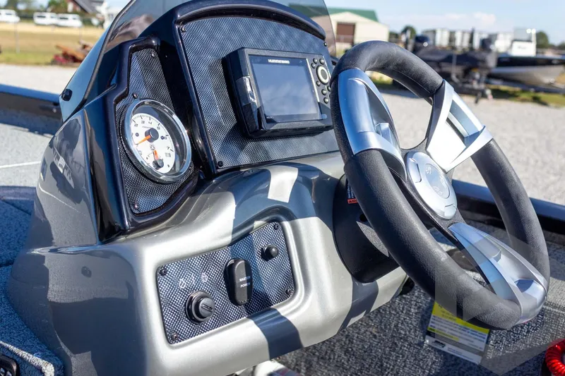Slide: The Image of 2026 G3 Sportsman 1610 boat dashboard with steering wheel and control panel. - 35
