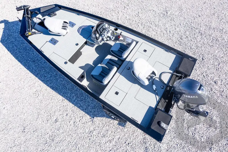 Slide: The Image of 2026 G3 Sportsman 1610 boat with Yamaha motor, aerial view on gravel surface. - 51