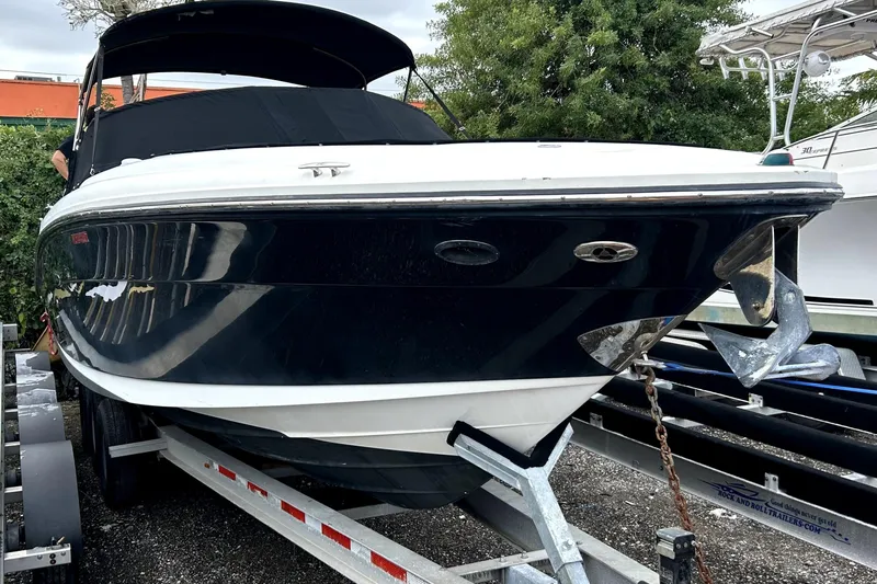 The Image of 2005 Sea Ray SLX 280 boat on trailer under blue sky. - 0