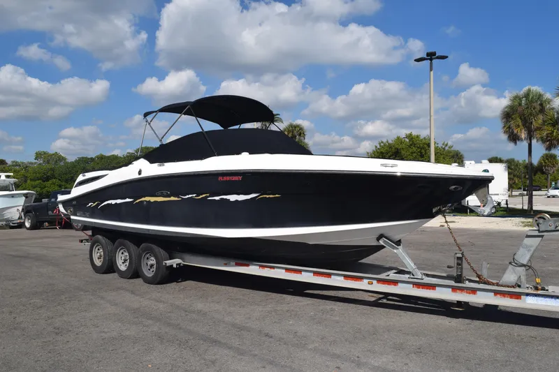 Slide: The Image of 2005 Sea Ray SLX 280 boat on trailer under blue sky. - 12