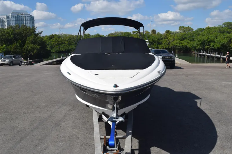 Slide: The Image of 2005 Sea Ray SLX 280 boat on trailer at a sunny marina. - 13