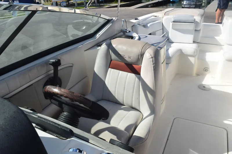 Slide: The Image of 2005 Sea Ray SLX 280 boat interior with seating, under a partly cloudy sky. - 24