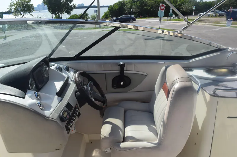 Slide: The Image of 2005 Sea Ray SLX 280 boat interior with steering wheel and seating. - 25