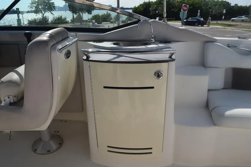 Slide: The Image of 2005 Sea Ray SLX 280 boat interior with seating and sink, near waterfront. - 30