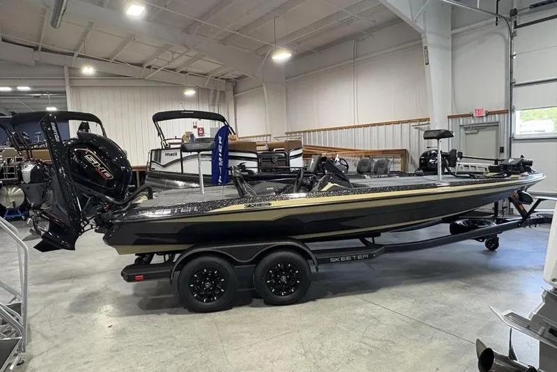 The Image of 2026 Skeeter ZXE20 boat in showroom, black and gold design, on trailer. - 1
