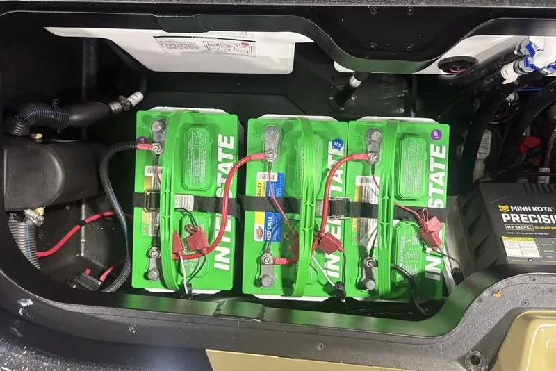 Slide: The Image of Three Interstate batteries in a 2026 Skeeter ZXE20 boat, connected with red and black cables. - 26
