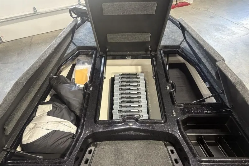 Slide: The Image of 2026 Skeeter ZXE20 boat storage compartments with organized gear and equipment. - 4
