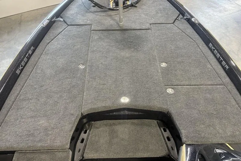 Slide: The Image of 2026 Skeeter ZXE20 boat deck with gray carpet and storage compartments. - 5